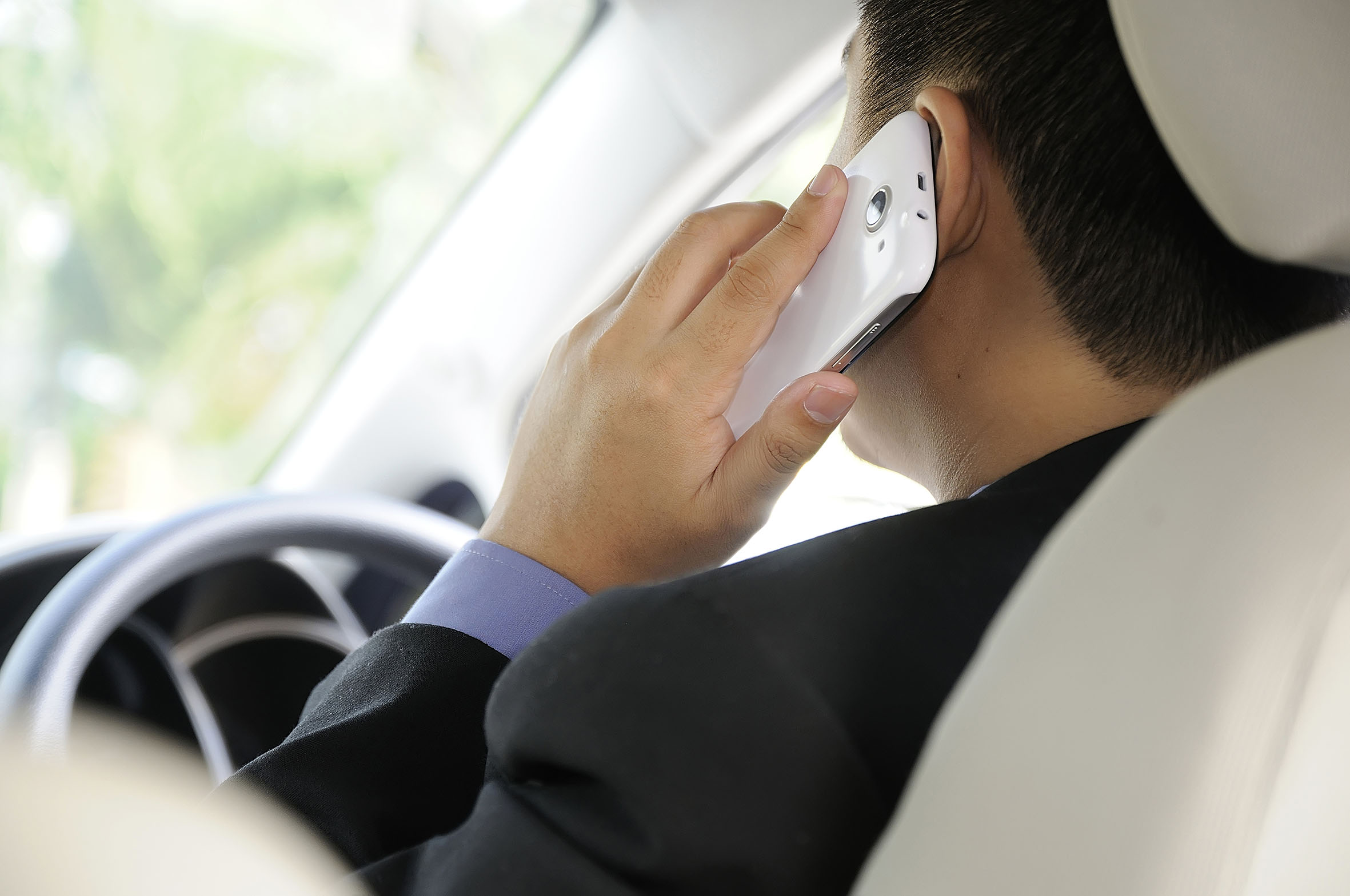 Man using a mobile phone whilst driving