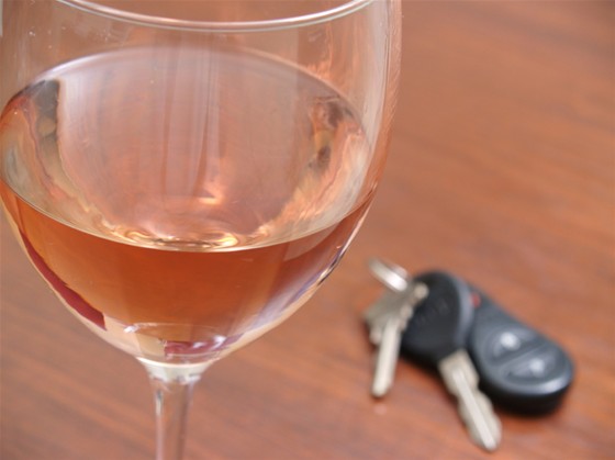 Person drinking wine before getting to the car